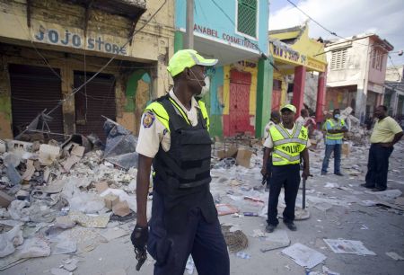 Haitian police patrol at a street in Haitian capital Port-au-Prince on January 16, 2010. 