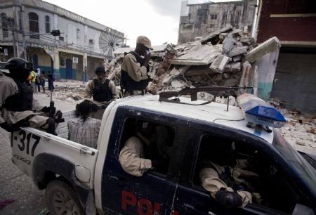 Haitian police patrol at a street in Haitian capital Port-au-Prince on January 16, 2010. The situation in Haiti is worsened by occasional looting in the aftermath of a devastating earthquake on January 12.