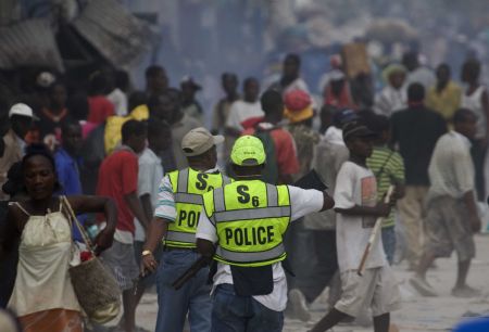 Haitian police patrol at a street in Haitian capital Port-au-Prince on January 16, 2010.