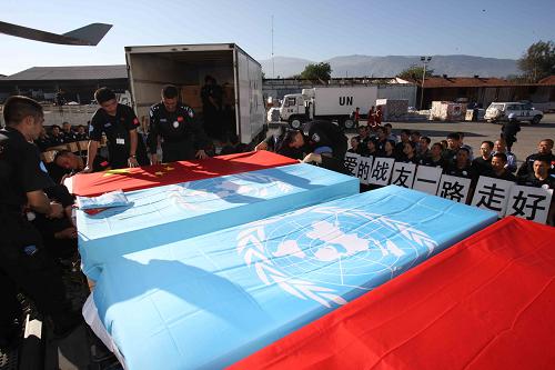 Flag-draped coffins of eight Chinese police officers who died in the Haiti quake are being unloaded from a UN truck for a trip back to China in Port-au-Prince, capital of Haiti, January 17, 2010.