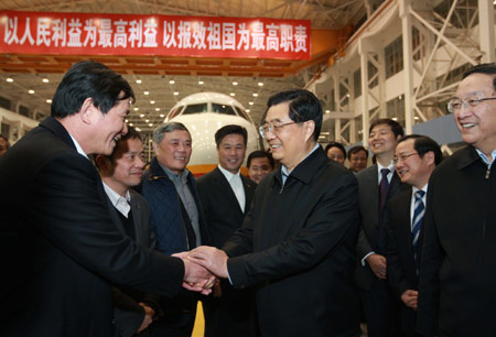 Hu Jintao (C, front), general secretary of the Central Committee of the Communist Party of China, Chinese president and chairman of the Central Military Commission, inspects Shanghai Aircraft Manufacturing Co., Ltd. of Commercial Aircraft Corporation of China Ltd. (COMAC) in Shanghai, east China, on January 14, 2010. 