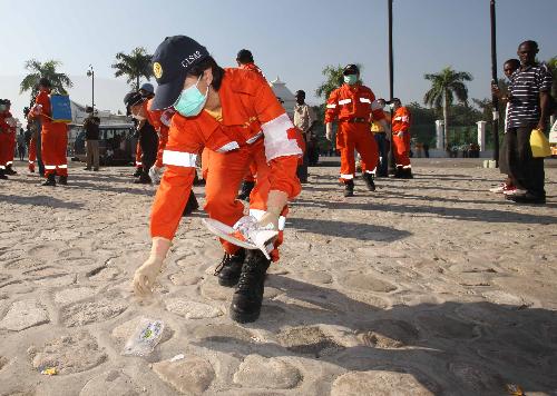 A medical worker of China International Search and Rescue Team (CISAR) clean up for a medical ground in Port-au-Prince, Haiti, January 18, 2010. 