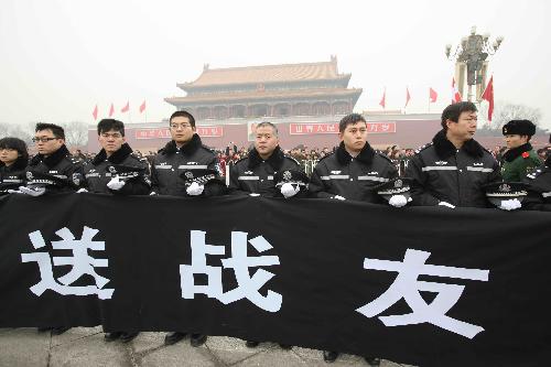 The police and mourners bid farewell to the coffins of the eight peacekeeping police officers who were killed in the Haiti earthquake at the Chang'an Street in Beijing, China, January 19, 2010.