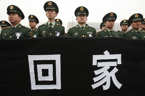 The police bid farewell to the coffins of the eight peacekeeping police officers who were killed in the Haiti earthquake at the Chang'an Street in Beijing, China, January 19, 2010.