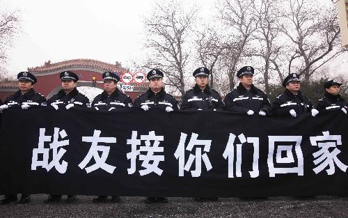 The police bid farewell to the coffins of the eight peacekeeping police officers who were killed in the Haiti earthquake at the Chang'an Street in Beijing, China, January 19, 2010.