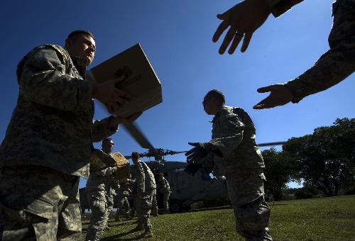 US soldiers transport relief goods in Port-au-Prince, Haiti, on January 18, 2009. More international relief goods arrived here on Monday.