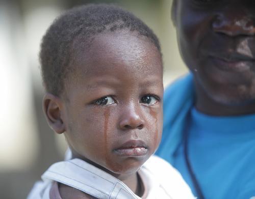 A child cries in an orphanage in Port-au-Prince, capital of Haiti, January 19, 2010. Fifty children and six workers lived in a temporary shelter with few food and tents after the orphanage building was devastated in the strong earthquake on January 12.