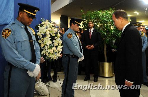 UN Secretary-General Ban Ki-moon (R) stands in silent tribute after presenting a wreath during a candle vigil mourning Haitian earthquake victims at UN Headquarters in New York January 19, 2010.