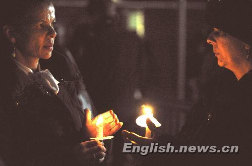 Two women holding candles attend a vigil mourning Haitian earthquake victims at UN Headquarters in New York January 19, 2010. 