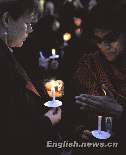 Two women hold candles while attending a vigil mourning Haitian earthquake victims at UN Headquarters in New York January 19, 2010.