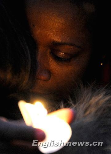 A woman attends a vigil mourning Haitian earthquake victims at UN Headquarters in New York January 19, 2010. 
