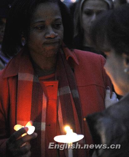 People hold candles while attending a vigil mourning Haitian earthquake victims at UN Headquarters in New York January 19, 2010.