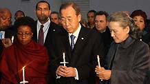 UN Secretary-General Ban Ki-moon (Front C) holds a candle during a vigil mourning Haitian earthquake victims at UN Headquarters in New York January 19, 2010.