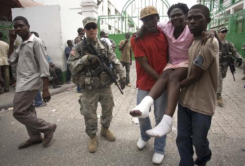 A wounded woman is transported to the hospital in Port-au-Prince, Haiti, January 18, 2010. 