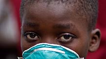 A local kid wears a mask to prevent the odorous smell in Port-au-Prince, Haiti, January 18, 2010.