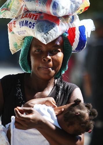 A Haitian woman queues to receive aid supplies in Port-au-Prince, Haiti, January 20, 2010. 