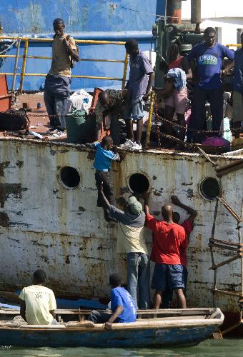 Local citizens try to flee this destroyed city by boat in Port-au-Prince, Haiti, January 20, 2010. 