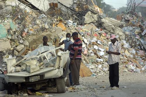 Survivors of the quake pass a site of ruins in Port au Prince, Haiti, January 20, 2010. 