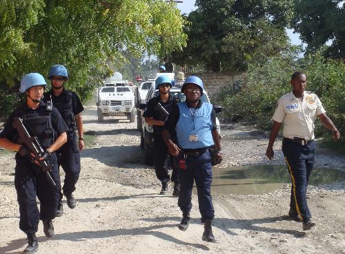 This file photo shows members of Chinese formed police unit patrol in the street of Port-au-Prince, Haiti.
