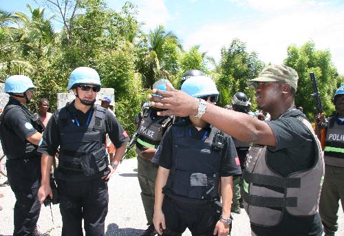 Members of Chinese formed police unit in Haiti operate a duty under the direction of Li Qin (2nd, L), who was killed during the quake, in Haiti, in August, 2006.
