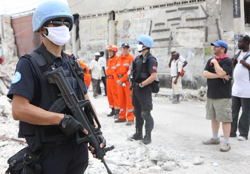 He Can, a member of Chinese formed police unit in Haiti, stands guard on the street of Port-au-Prince, Haiti, January 19, 2010.