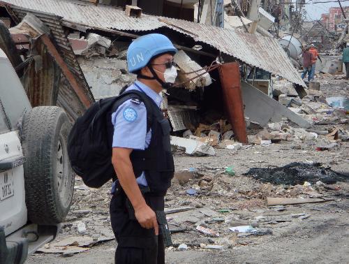 Gao Zhihe, a member of Chinese formed police unit in Haiti, stands guard on the street of Port-au-Prince, Haiti, January 20, 2010.