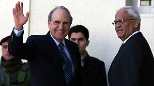 US Middle East Envoy George Mitchell (L) waves to journalists upon his arrival to meeting with Palestinian President Mahmoud Abbas in the West Bank city of Ramallah on January 22, 2010. President Abbas urged during the meeting Washington to work on dropping Israeli conditions that prevent the resumption of peace talks.