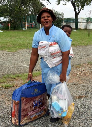 A local woman receives articles donated from overseas Chinese in Diepkloop, Soweto, Johannesburg, South Africa, January 22, 2010. 