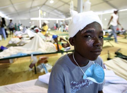 A Haitian boy rests after receiving treatment at a medical assistance station in Port-au-Prince, Haiti, January 22, 2010. Nine medical teams, including US, France, Russia, China, provide medical treatments for Haiti in this station.
