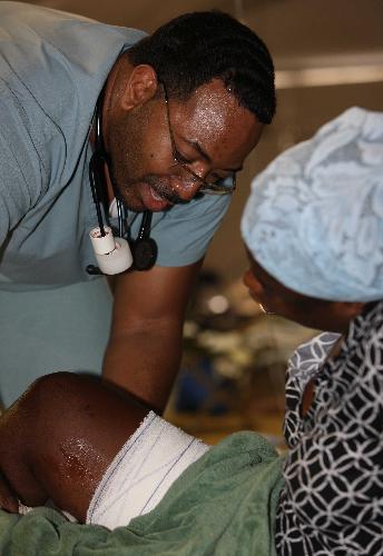 A Haitian woman receives treatment at a medical assistance station in Port-au-Prince, Haiti, January 22, 2010. Nine medical teams, including US, France, Russia, China, provide medical treatments for Haiti in this station.