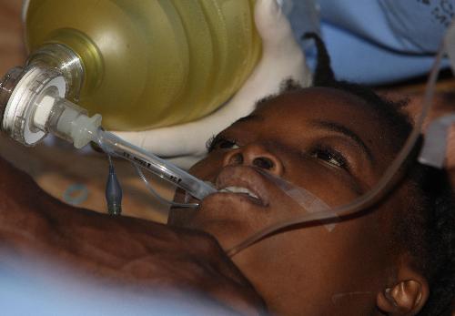 A Haitian child receives treatment at a medical assistance station in Port-au-Prince, Haiti, January 22, 2010. Nine medical teams, including US, France, Russia, China, provide medical treatments for Haiti in this station.