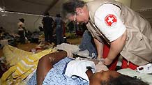 A Haitian woman receives treatment at a medical assistance station in Port-au-Prince, Haiti, January 22, 2010. Nine medical teams, including US, France, Russia, China, provide medical treatments for Haiti in this station.