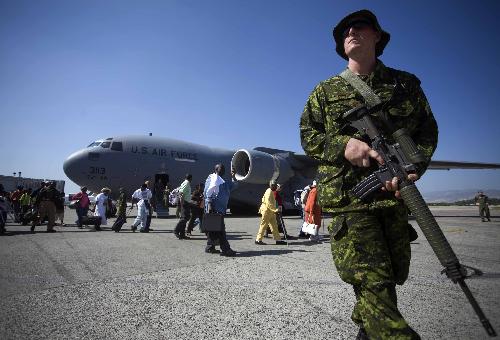 People get ready to go aboard a plane to the United States in Port-au-Prince, Haiti, January 22, 2010.