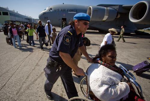 People get ready to go aboard a plane to the United States in Port-au-Prince, Haiti, January 22, 2010.