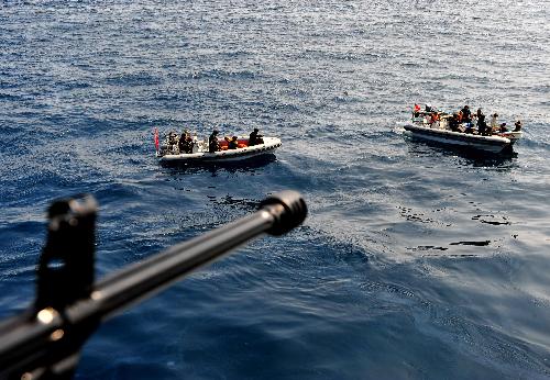 Chinese navy soldiers check a doubtable yacht in the Gulf of Aden, on January 22, 2010. The frigate is on an escort mission as part of a Chinese naval flotilla.