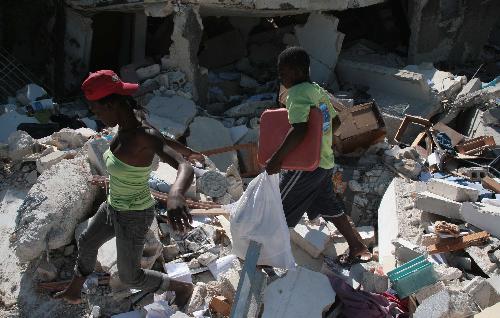 People scavenge in the ruins of a building in Port-au-Prince, Haiti, January 23, 2010. 
