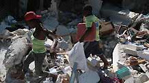 People scavenge in the ruins of a building in Port-au-Prince, Haiti, January 23, 2010.