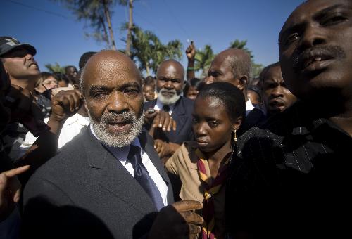 Haitian President Rene Preval takes part in the funeral service for Haitian Archbishop Joseph Serge Miot, who was killed in last week's devastating earthquake, outside Notre Dame d'Assumption Cathedral in Port-au-Prince January 23, 2010.