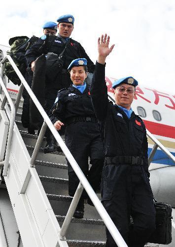 Members of Chinese peacekeeping police officers step down from the plane at an airport in Port-au-Prince, capital of Haiti, on January 25, 2010.