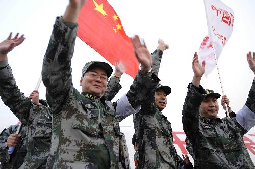 Members of the Chinese medical care and epidemic prevention team wave before boarding a chartered flight for Haiti, at Capital International Airport in Beijing, capital of China, on January 24, 2010. 