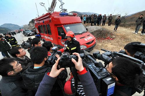 A fireman speaks to reporters near the site of explosion at the Changjin Firecrackers Plant in Taolin Town of Linxiang City, central-south China's Hunan Province, January 26, 2010.
