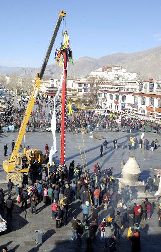 Workers replace prayer streamers around the Jokhang Temple in Lhasa, capital of southwest China&apos;s Tibet Autonomous Region, January 26, 2010.