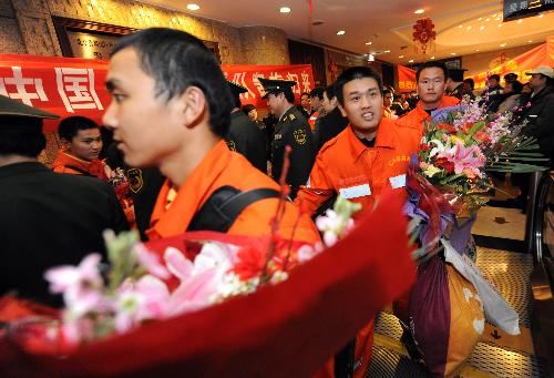 Members of China International Search and Rescue Team (CISAR) arrive at Capital International Airport in Beijing, capital of China, on January 27, 2010.