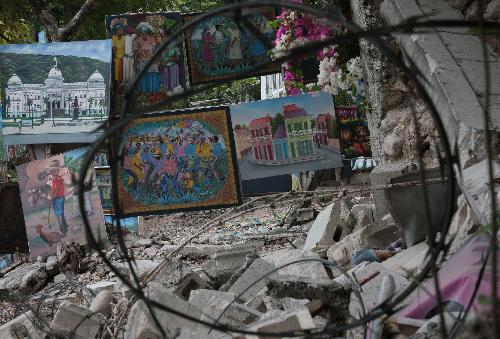 A few oil paintings for sale are placed on the rubble of a destroyed building in Haitian capital Port-au-Prince on January 25, 2010. Life for locals began to recover from the chaos caused by a catastrophic earthquake that rocked the city on January 12.