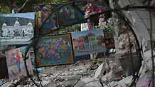 A few oil paintings for sale are placed on the rubble of a destroyed building in Haitian capital Port-au-Prince on January 25, 2010. Life for locals began to recover from the chaos caused by a catastrophic earthquake that rocked the city on January 12.