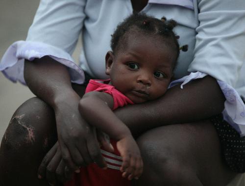 A mother holds her child in Haitian capital Port-au-Prince on January 25, 2010.