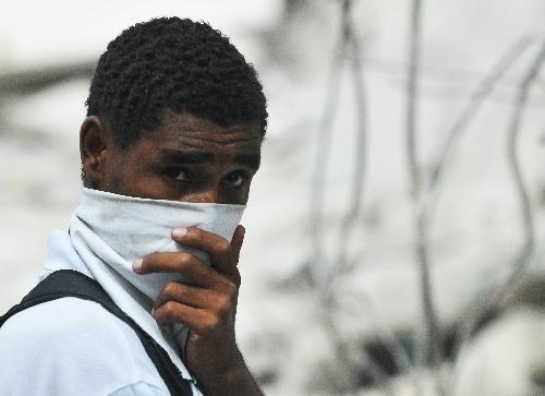 A man covers his nose and mouth in Haitian capital Port-au-Prince, on January 26, 2010, the 15th day after the catastrophic earthquake. 