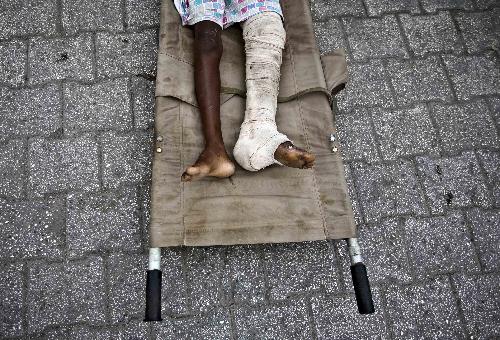 A person injured in the earthquake waits for treatment in a hospital in Port-au-Prince, capital of Haiti, January 26, 2010.