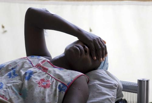 A woman injured in the earthquake rests after the amputation in a hospital in Port-au-Prince, capital of Haiti, January 26, 2010.