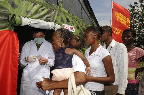 Haitians wait to receive medicine at a makeshift hospital set up by a Chinese medical team in Port-au-Prince January 27, 2010.